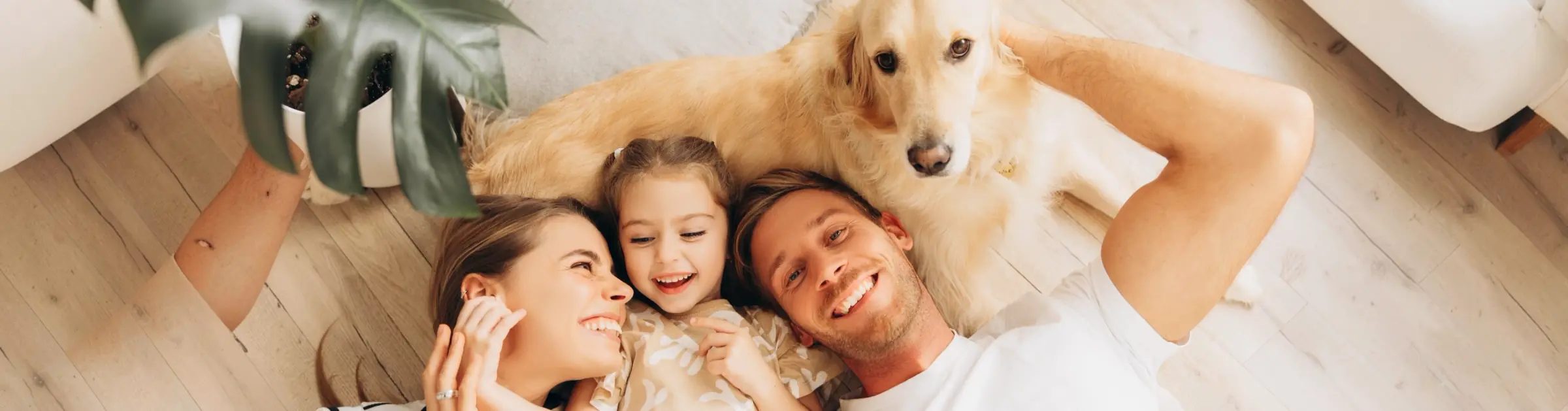 Família deitada no chão de casa com o cachorro